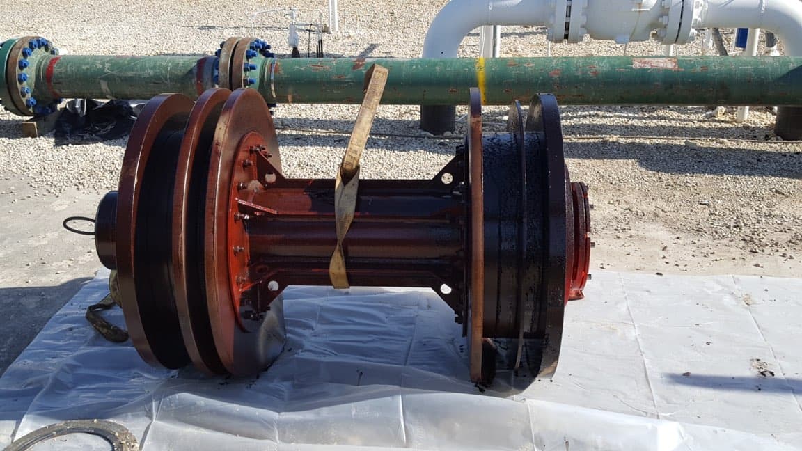 Cleaned and rebuilt pump rotor in front of SWD-yard pipeline.