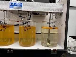 Lab gang-stirrer running jar tests on produced-water samples.